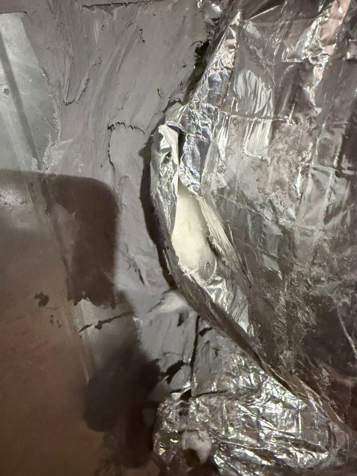 Upon arrival client stated that there were rips in the duct work on the supply side on the upstairs unit. I inspected the unit and found that it’s where the manual damper lever is coming out of the duct and explained that it’s normal for those lever spots to have a rip. No air was going into the attic from those spots. 