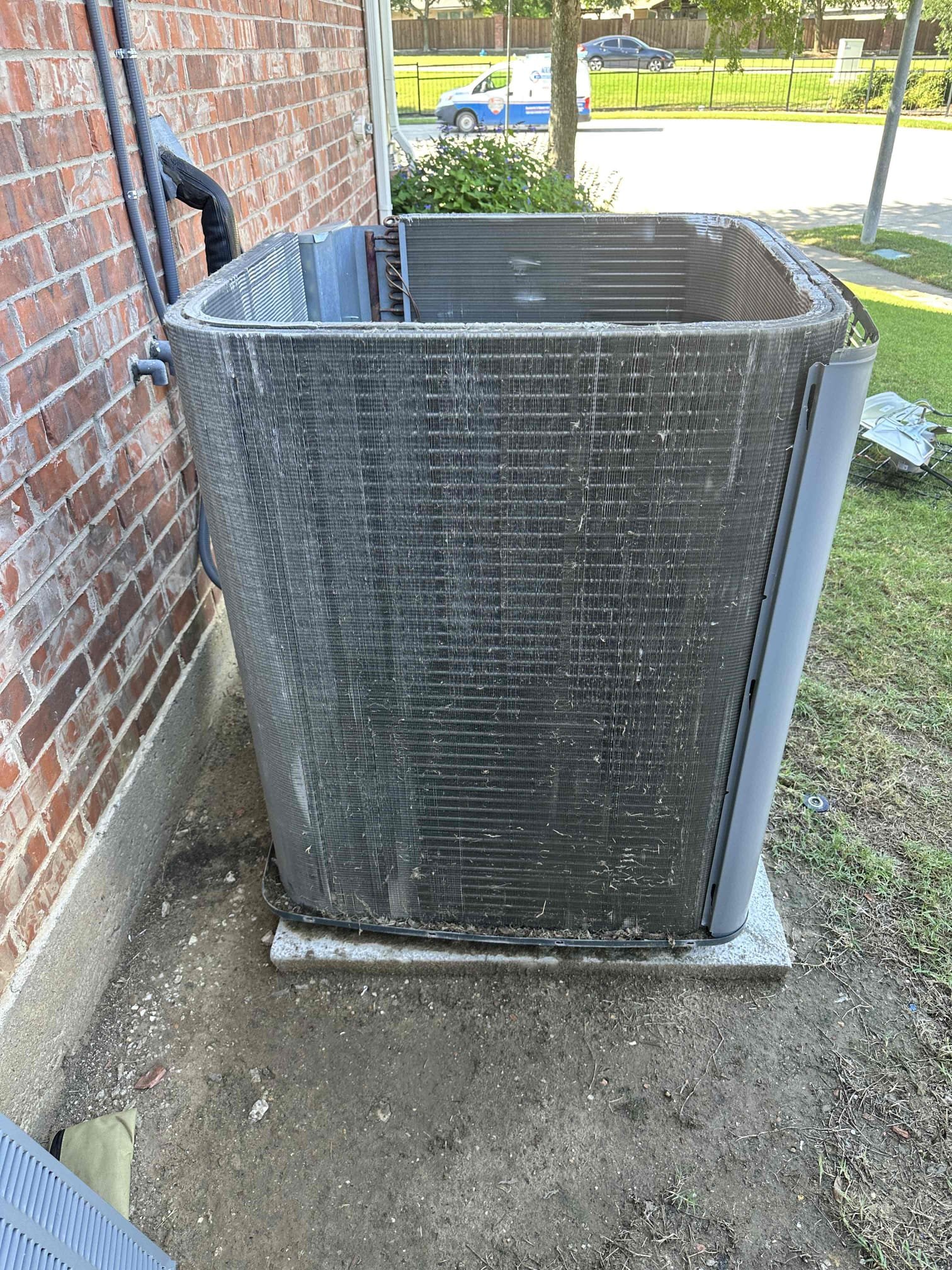 The condensing coil fins have sustained damage. This is causing an air restriction and puts additional wear on the compressor and condenser fan motor. 
**Could’ve been caused by a hail storm, but origin of the damage is unknown**