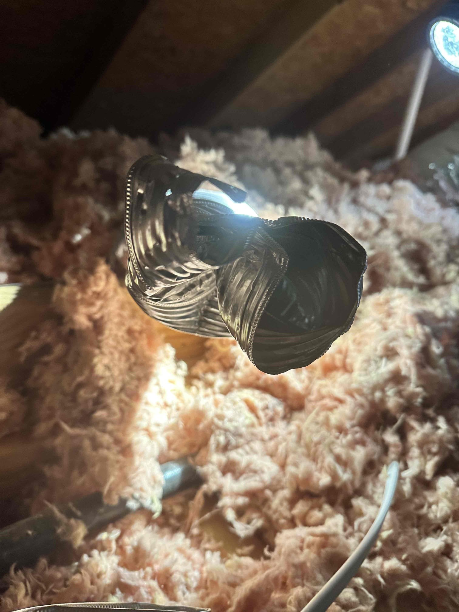 Exhaust pipe for be toilet room is crushed and broken. The only part where the air could flow was covered in insulation. Customer approved cutting apart the vent to open it back up and secure it with metal tape. I provided a service agreement pamphlet to the customer upon departure.
