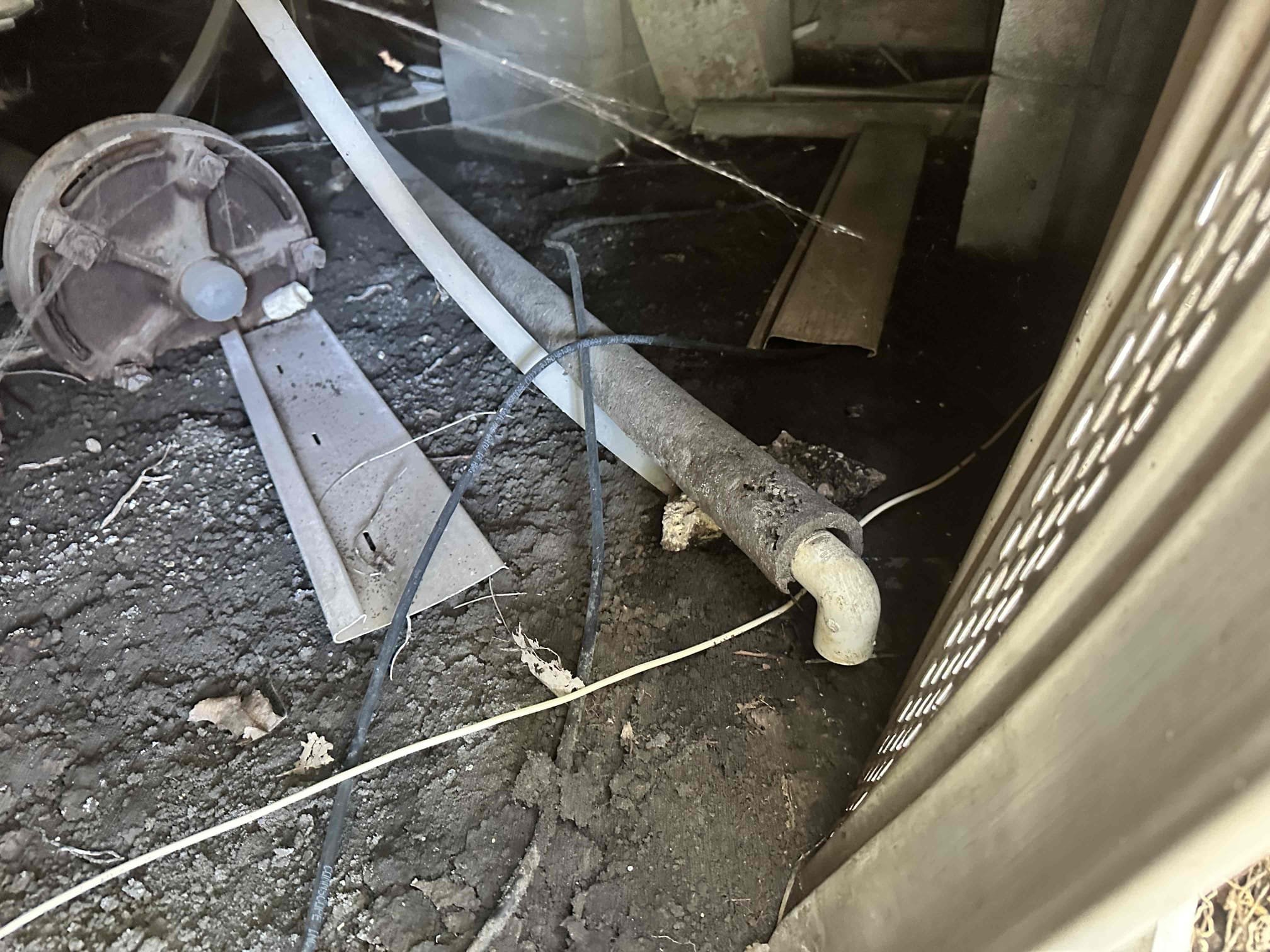 Sherman, TX - Upon arrival, the customer gave me more information on the water being in the pan. She stated that the water would over flow indicating that there is a clog present. I managed to locate the termination point under the house. After finding that, I was informed of an issue at the outdoor unit. The condenser fan motor is seized up. I presented pricing to address these issues at the time of service. 