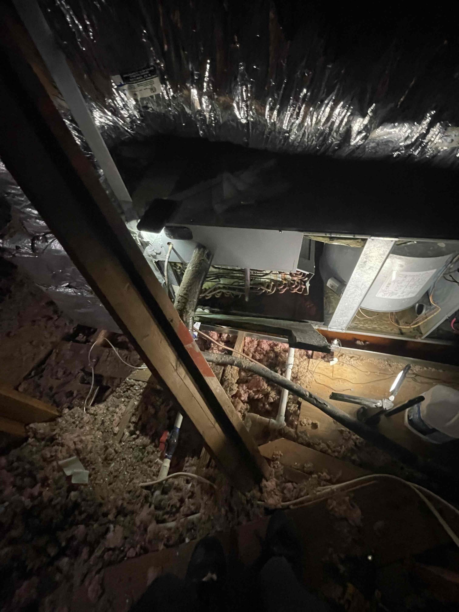 Arrived on site homeowner had water come through the ceiling directly below air handeler. Observed water spilling out of secondary line. Tested and found found primary drain line clogged and emergency drain pan full of water. Water on the ceiling could not have come from an overflow as secondary drain line is draining well. Found water inside blower cabinet. Upon further inspection it was found that there was water coming steadily off of insulation of return plenum on back side of unit. Poured water into primary drain pan and observed water leaking out of primary drain pan. This confirms there is a crack in the emergency drain pan that is allowing water to escape the condensate drain. Advised homeowner primary drain pan will have to be replaced in order to full stop the water. Advised that unclogging the drain line will cause less water to leak out but some will still make it out. Informed homeowner that coil pan should be arriving on Tuesday. 