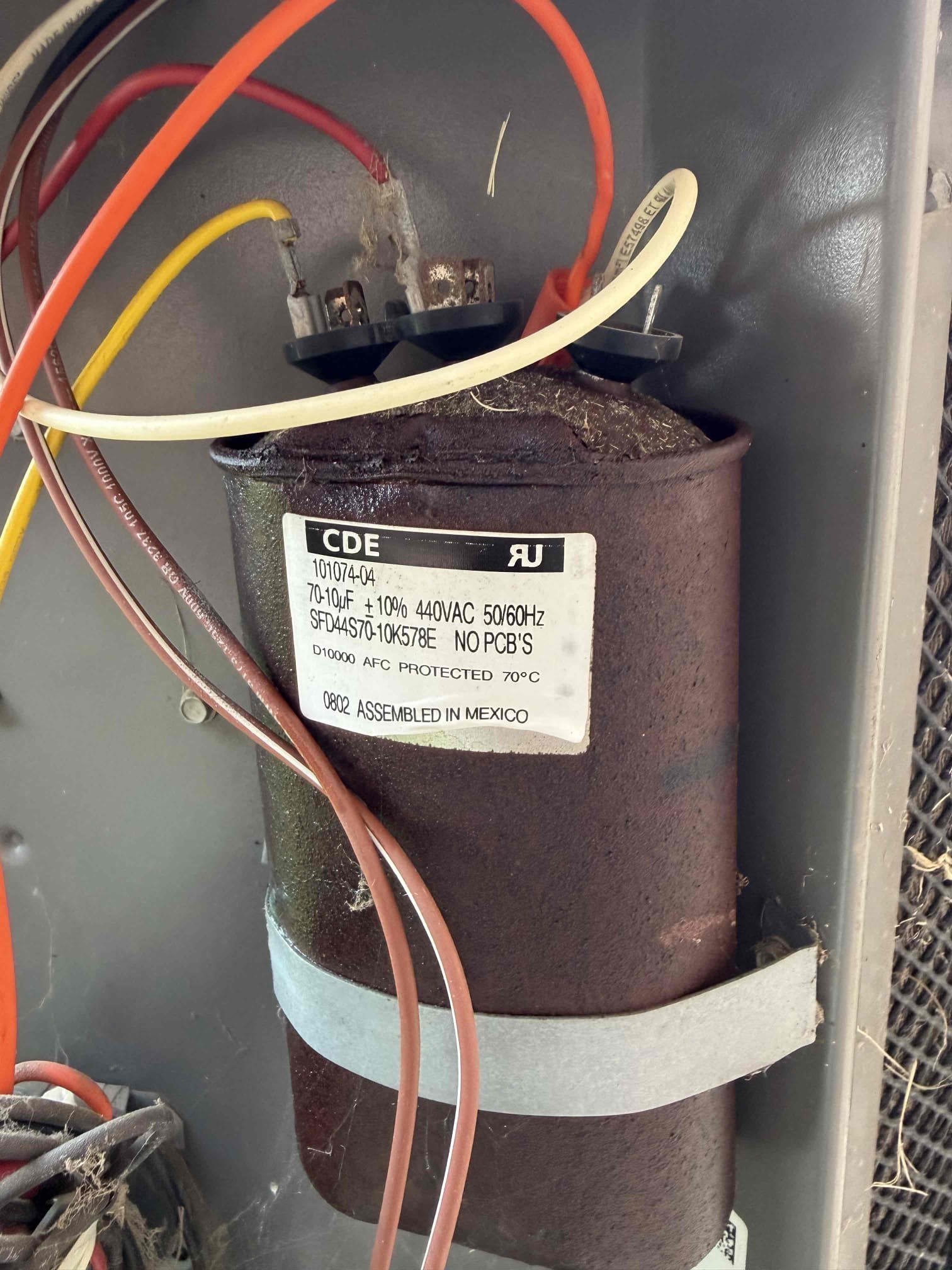 Upon arrival, I found the outdoor fan motor running. It had been replaced. I discovered that the compressor capacitor had ruptured. I presented options for replacement. The client opted to install a Turbo200x. I tested the system afterwards to ensure system is cooling properly. System is cooling upon departure.