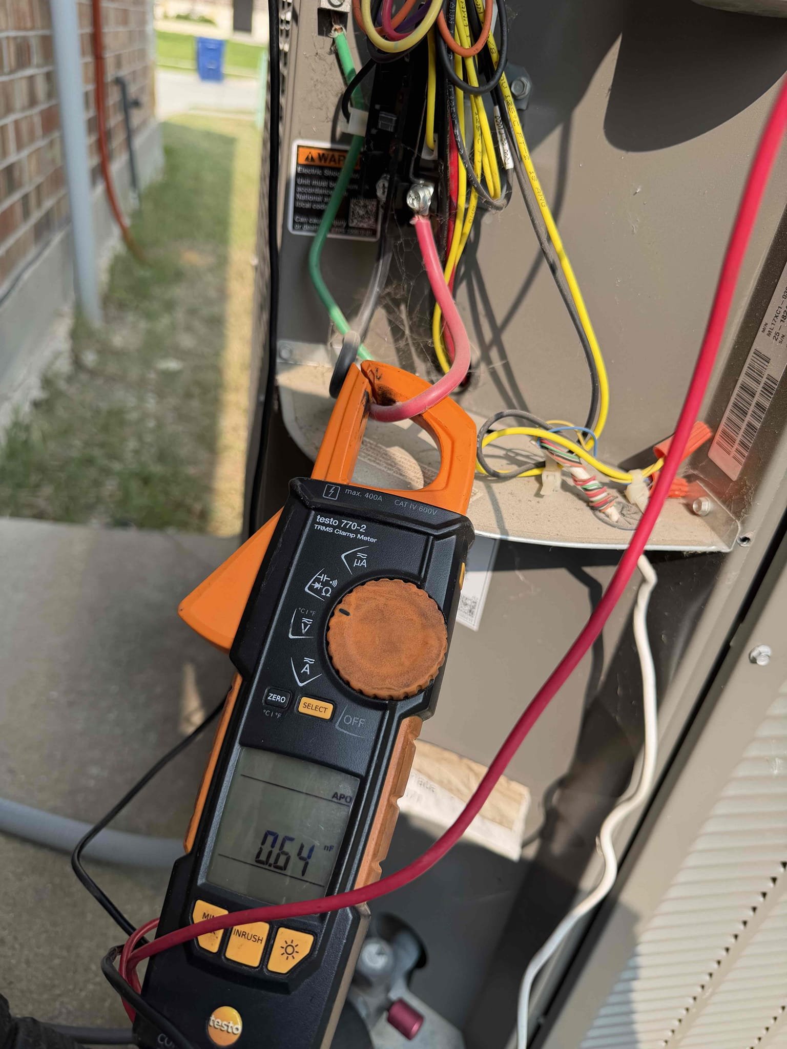 Upon arrival, I discovered that the compressor was not turning on and the condenser fan motor running backwards. After further assessment, I found the capacitor to be mostly dead on the fan and compressor terminals. I wired a new capacitor in for testing purposes. The system came on and began cooling. I performed evaluation of the entire systems operation and discovered that the outdoor unit needed a rinsing, as well. The system is cooling upon departure. 