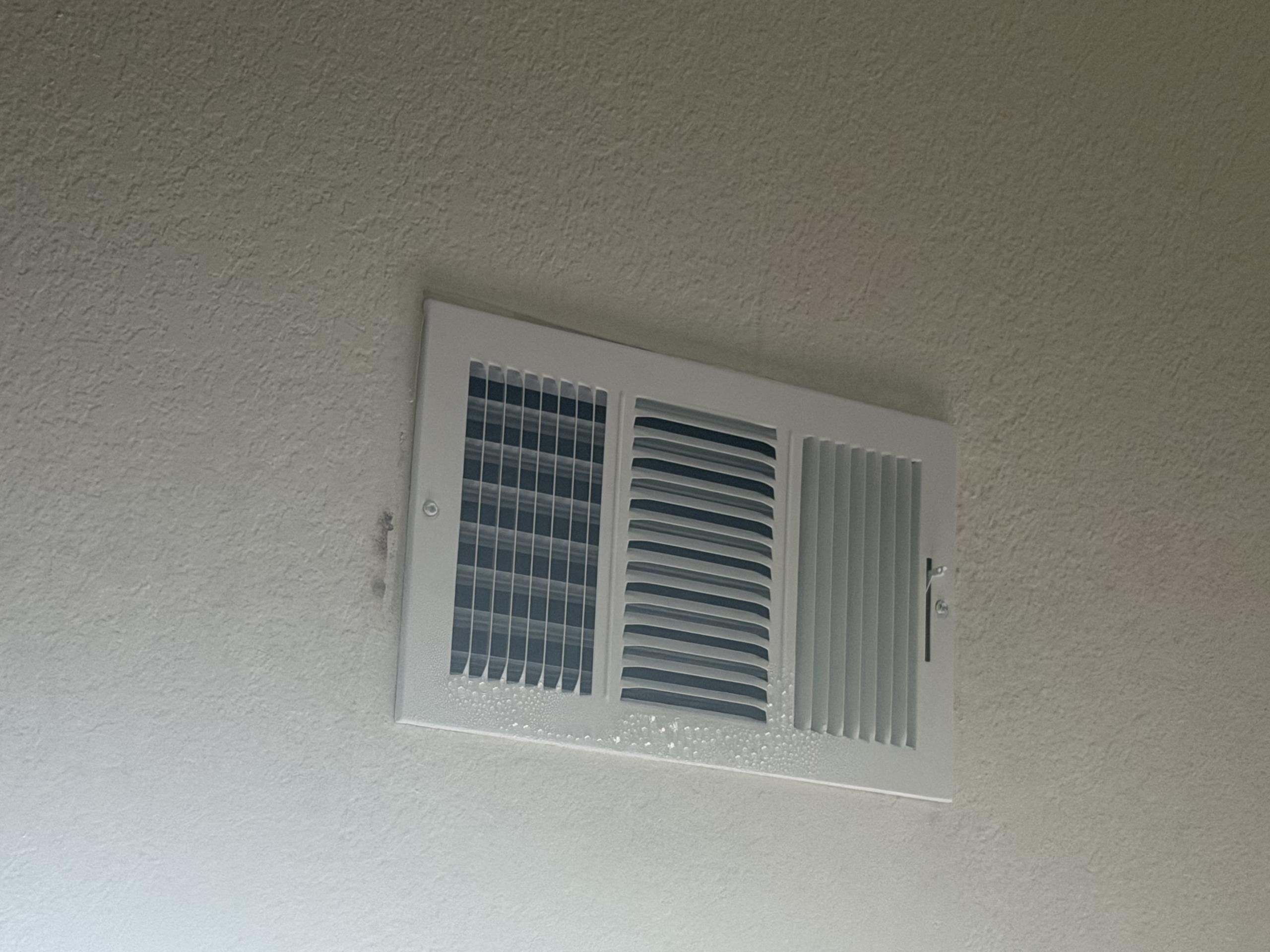 Carrollton, TX - The customer has a supply air vent located in the kitchen directly beside a skylight. During inspection, it was determined that heat radiating from the skylight was affecting the supply register. The combination of the hot air around the skylight and the cold conditioned air from the supply vent was causing condensation (sweating) to form on the supply grille.

To help correct the issue, I adjusted and redirected the supply airflow across the ceiling and away from the skylight. This prevents the conditioned air from interacting directly with the concentrated heat coming from the skylight.

By diverting the airflow farther across the ceiling, the temperature difference around the supply register should be reduced, which should eliminate or significantly reduce the sweating/condensation on the supply grille.

Work Performed: Adjusted the supply register airflow direction to improve air distribution and address the condensation issue.