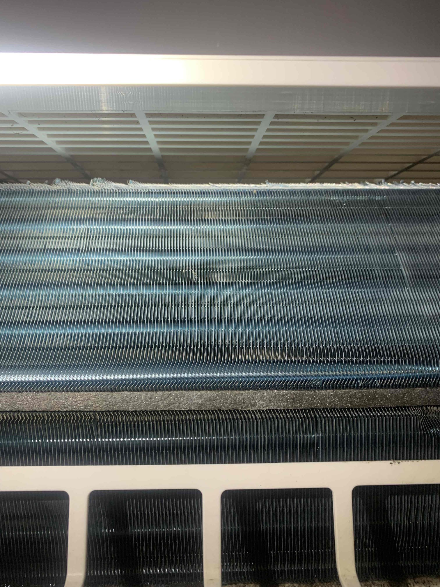 Mini split is leaking water out of bottom. Found that it was dripping from same spot as last year. Vacuumed water out of pan through drain line, it is clear. All piping is connected and water is still dripping from under pan. There is a hairline crack on right side of drain pan. Water is leaking through crack and out the bottom of unit. Need to look into if we can replace only the drain pan or not. 