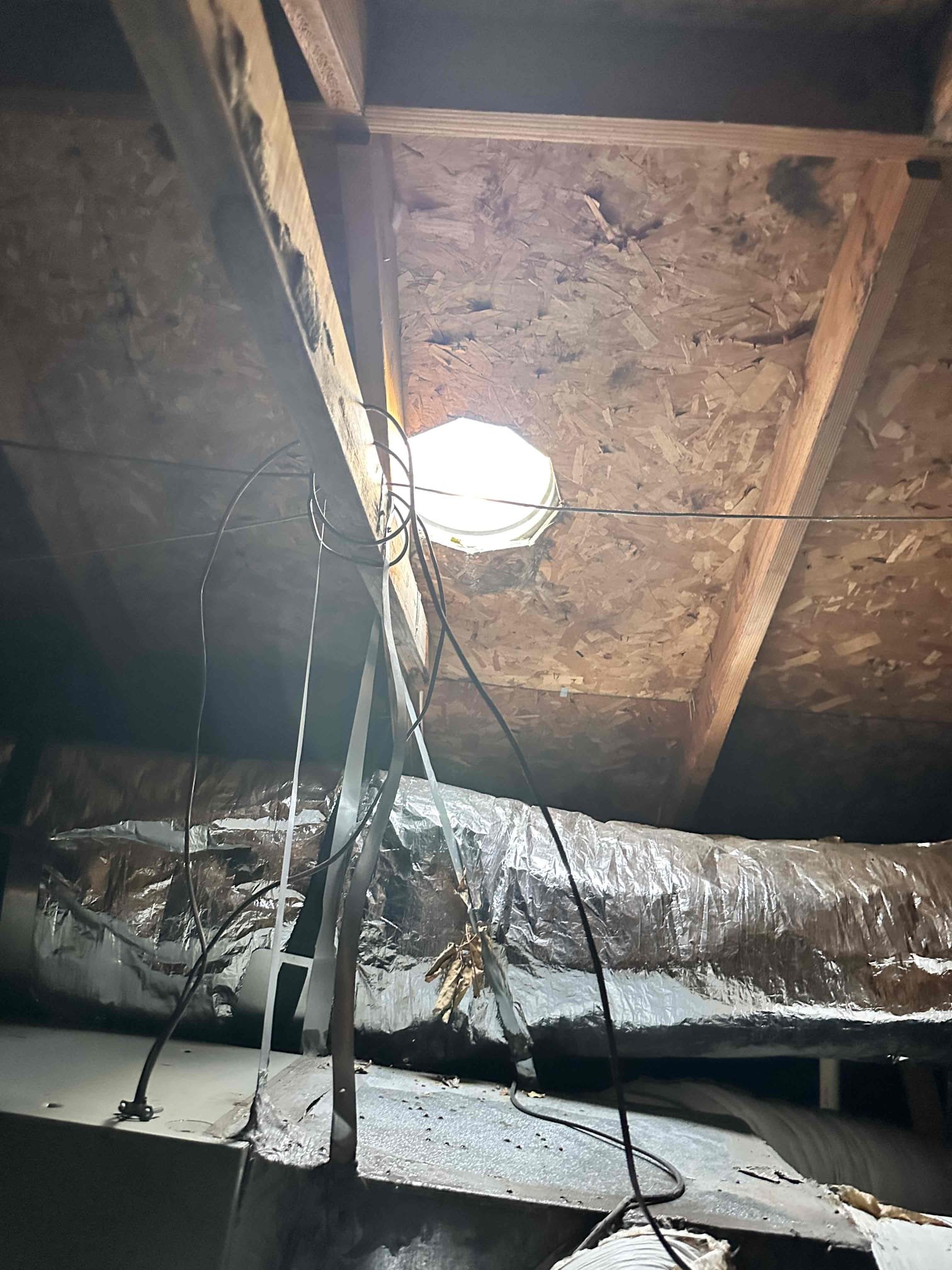 Denison, TX - Customer had concerns about water coming from soffit. Found that primary drain line was clogged and water was draining into secondary drain pan. Offered level 2 drain clearing to also remove water from pan, customer declined and only wanted drain line blown out. Cut and blew out drain line using nitrogen both directions. Poured water down drain line to verify it was clear. System is cooling at this time. 

There is a missing roof vent cap directly above system. It is not part of the HVAC system. 