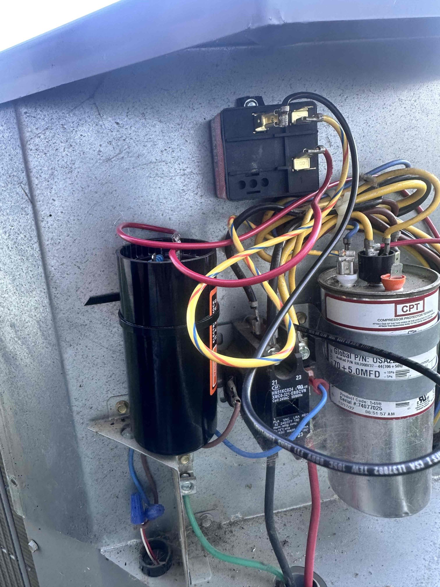 Sherman, TX - Arrive for no Cool. Customer stated that indoor unit was blowing air and outside fan was running, but there was no cold air coming through the vents. Took panel off outdoor unit and noticed a burning smell. Check capacitor, and it is still good. Noticed that top of hard start kit capacitor was black. Tested hard start kit and it had failed. We installed it earlier last year and they come with three-year warranty. Replaced hard start kit under parts only warranty. Check trough on compressor when it started. Compressor is operating with within acceptable range. System is cooling at this time.