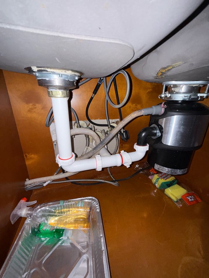 Work Performed:
	•	Removed entire waste bends from double bowl kitchen sink
	•	Reason for removal was sinks were not properly trapped
	•	Supplied and installed new waste piping for double bowl kitchen sink including disposal connection
	•	Installed new properly vented trap
	•	Tested drainage and connections for proper operation and no leaks present
	•	Cleaned up work area upon completion.