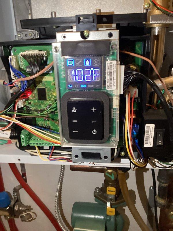 Responded to service call for in-floor heating system displaying E110 error code (blocked line). Performed inspection of exhaust and intake pipes, cleared condensate drain trap to restore proper venting. System was operational with no error codes during final testing.