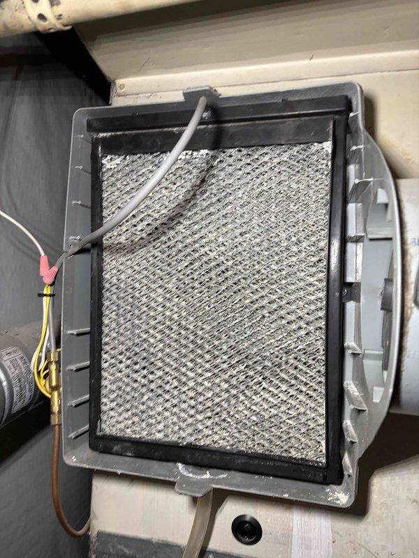 Performed scheduled heating tune-up on customer's system, including inspection and maintenance of one furnace and Aprilaire Model #600A whole-home humidifier. Inspected air filtration system, noting some dust accumulation on the filter mesh. All components functioning properly after service.