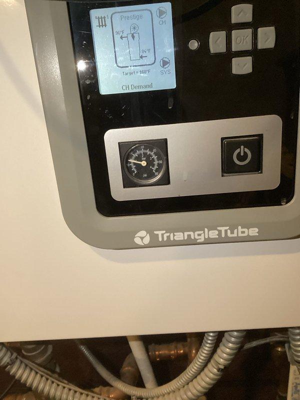 Completed prepaid maintenance visit on Triangle Tube boiler system and gas fireplace. System inspection found boiler operating normally with proper temperature settings and pressure levels. Customer reported potential water damage in kitchen after bleeding upstairs radiator; company will follow up regarding possible water line issue.