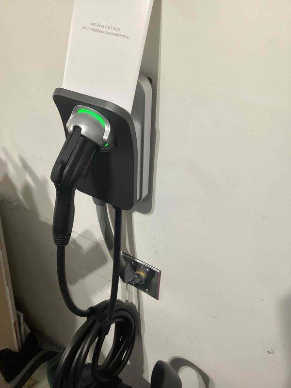 Installed a ChargePoint EV charging station with load management capability in a 100A electrical panel. Implemented a Load Management Device (LMD) to automatically disable the charger when household consumption exceeds capacity, ensuring code compliance. Converted existing NEMA 14-50R receptacle to a junction box, hardwired the unit for 40A output (50A fused), and configured the charger's WiFi connectivity and app settings.