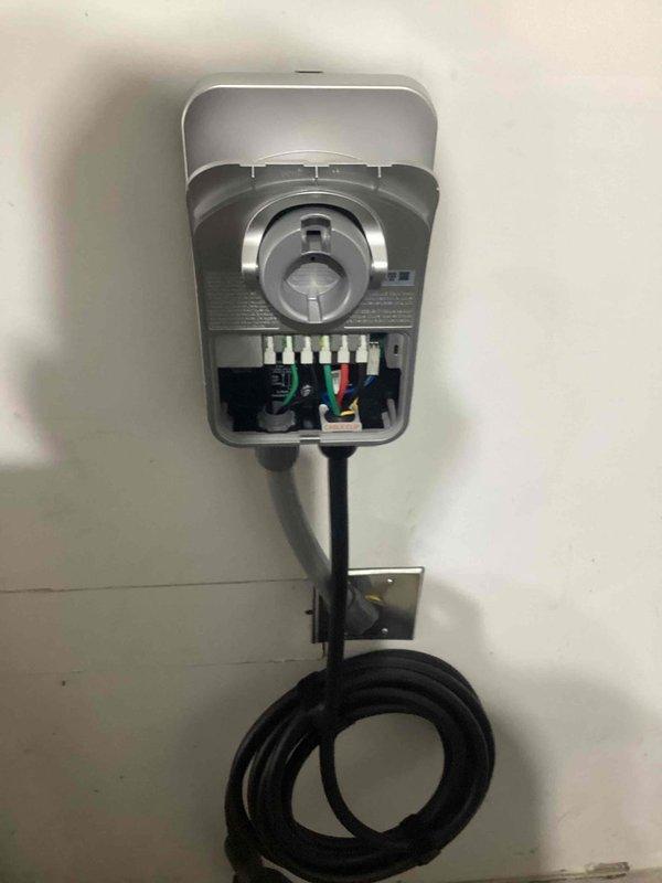 Installed a ChargePoint EV charging station with load management capability in a 100A electrical panel. Implemented a Load Management Device (LMD) to automatically disable the charger when household consumption exceeds capacity, ensuring code compliance. Converted existing NEMA 14-50R receptacle to a junction box, hardwired the unit for 40A output (50A fused), and configured the charger's WiFi connectivity and app settings.