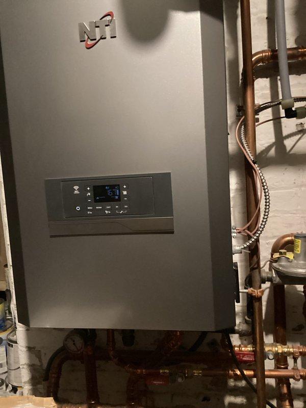 Responded to emergency call for overheating boiler system affecting multiple zones. Diagnosed faulty Taco zone control board preventing proper zone closure. Replaced control board and verified proper operation of NTI boiler system with temperature now regulated at 69°F. All zones now functioning correctly with no overheating issues.
