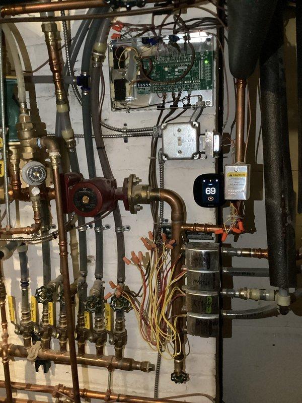 Responded to emergency call for overheating boiler system affecting multiple zones. Diagnosed faulty Taco zone control board preventing proper zone closure. Replaced control board and verified proper operation of NTI boiler system with temperature now regulated at 69°F. All zones now functioning correctly with no overheating issues.