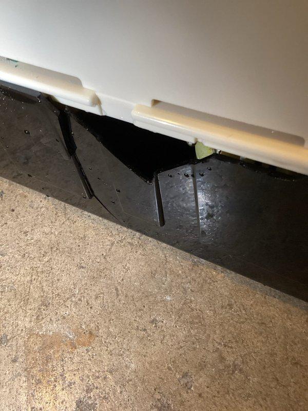 Responded to service call for recurring condensate pump leak. Upon inspection, found damaged condensate pump with broken component on rear section, showing evidence of water damage to surrounding baseboard. Replaced faulty condensate pump to resolve the persistent leakage issue.