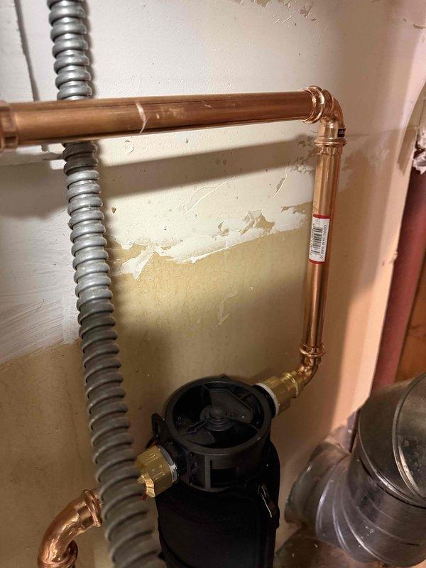 Successfully installed a Navien NCB240/110H combi system with primary manifold, replacing the existing unit. Connected all boiler and domestic water lines, added an expansion tank to the in-floor heat system, and installed anti-scale protection. Replaced the existing 3" cell core venting with code-compliant 3" solid core for both intake and exhaust, and confirmed proper system operation with no leaks present.