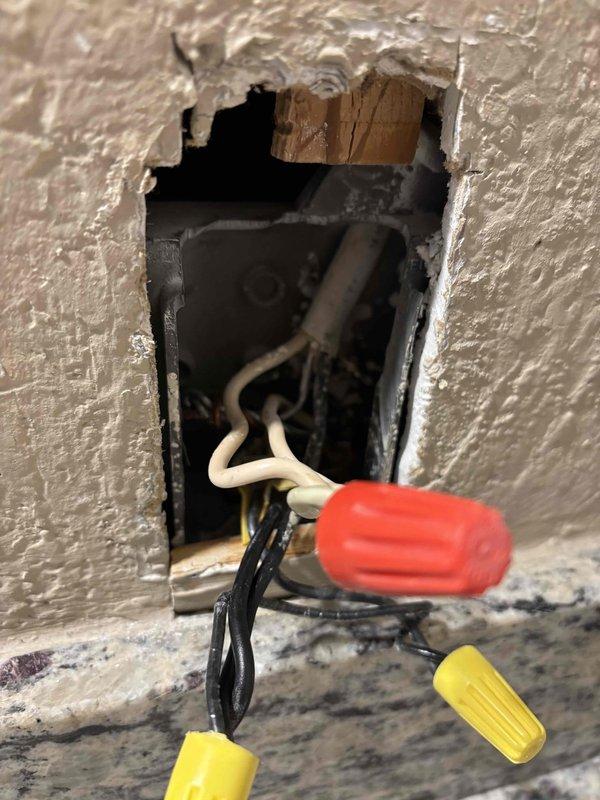 Responded to warranty service call regarding inoperative bathroom receptacle and light. Upon inspection, found damaged electrical connections in junction box requiring repair. Reconnected wiring with appropriate wire nuts and restored proper functionality to bathroom electrical components as per original service agreement.