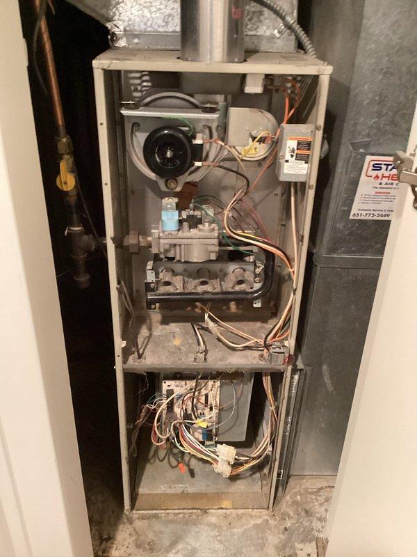Diagnosed furnace failure caused by faulty igniter as confirmed with digital clamp meter testing. Removed access panel, replaced defective igniter component, and verified proper ignition sequence and system operation before completing service.