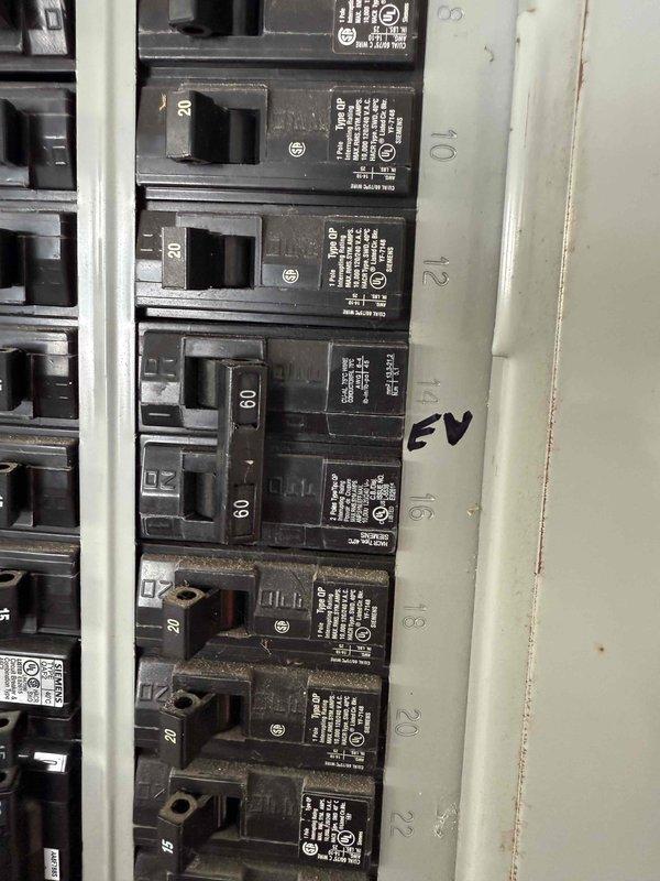 Successfully replaced an Enel X Juicebox EV charging station with customer-supplied Emporia EV charger. Extended flexible metal conduit from existing junction box to new charging unit location and verified proper connection to dedicated 60-amp circuit marked "EV" in electrical panel. Installation is complete and operational.