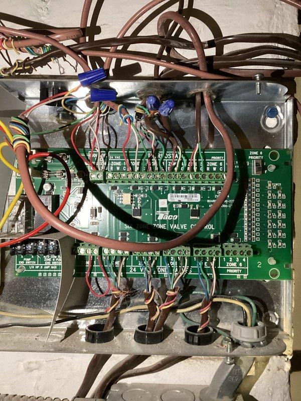 Responded to service request regarding boiler running hot. Upon inspection, identified faulty Taco zone board ZVC406-5 as the source of the issue. Removed existing damaged zone valve control system and installed new Taco zone board with proper wiring connections to all six zones, restoring normal operation of the boiler system.