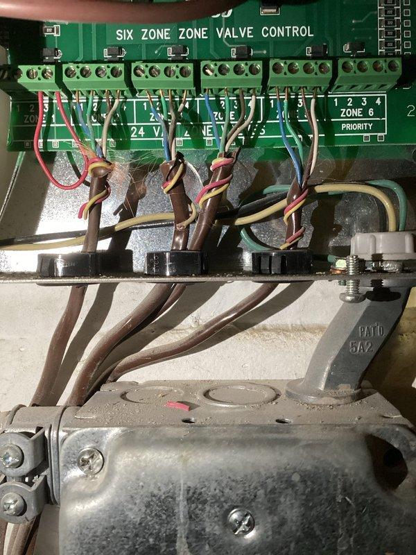 Responded to service request regarding boiler running hot. Upon inspection, identified faulty Taco zone board ZVC406-5 as the source of the issue. Removed existing damaged zone valve control system and installed new Taco zone board with proper wiring connections to all six zones, restoring normal operation of the boiler system.