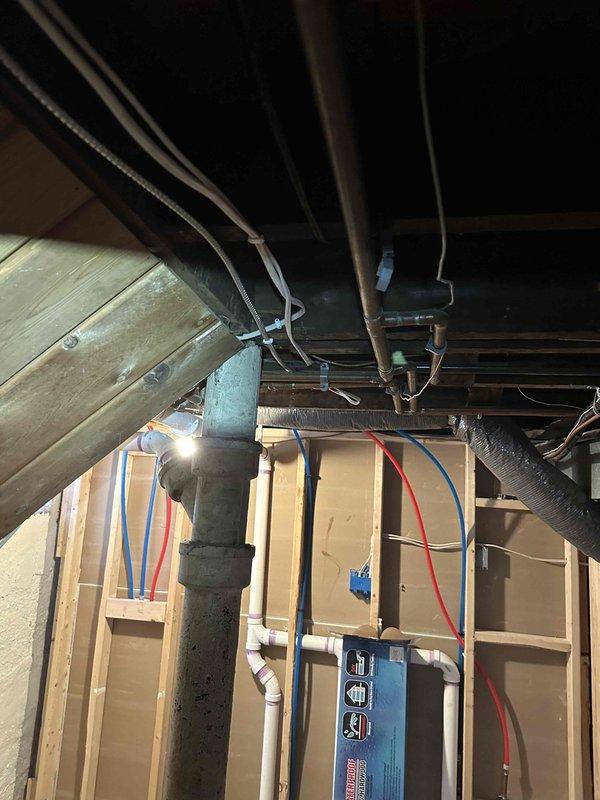 Completed comprehensive electrical work in bathroom renovation, including installation of new vanity light with dedicated switch, bathroom exhaust fan with timer control, and code-compliant dedicated circuit GFI outlet. Removed existing porcelain light fixture and relocated doorbell transformer. Work involved fishing wiring from basement panel through ceiling and crawl space to access bathroom. All installations completed with proper electrical permits and inspections.