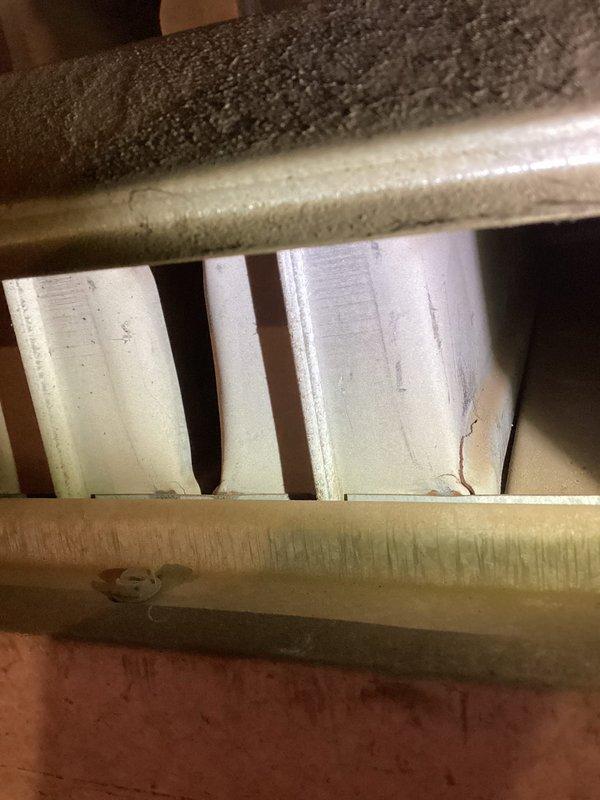 Responded to service call for warehouse garage heater not producing heat. Upon inspection, identified unit located approximately 10-12 feet high showing fault code 8701. Examination revealed heat exchanger failure. Red tagged the unit, shut down operation, and documented damage with photos showing heat exchanger deterioration and equipment positioning within the warehouse environment.