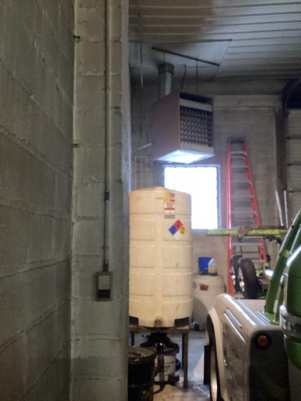 Responded to service call for warehouse garage heater not producing heat. Upon inspection, identified unit located approximately 10-12 feet high showing fault code 8701. Examination revealed heat exchanger failure. Red tagged the unit, shut down operation, and documented damage with photos showing heat exchanger deterioration and equipment positioning within the warehouse environment.