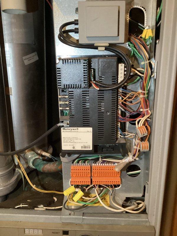 Responded to service call for non-functioning Triangle Tube boiler displaying error code E28. Upon inspection, found control panel inoperative with system in standby mode. Diagnosed issue with Honeywell control module and wiring connections. Reset system, checked pressure gauge readings, and confirmed proper operation of digital display interface. Located replacement parts needed to resolve fault code E28. System now operational with house temperature returning to normal range.