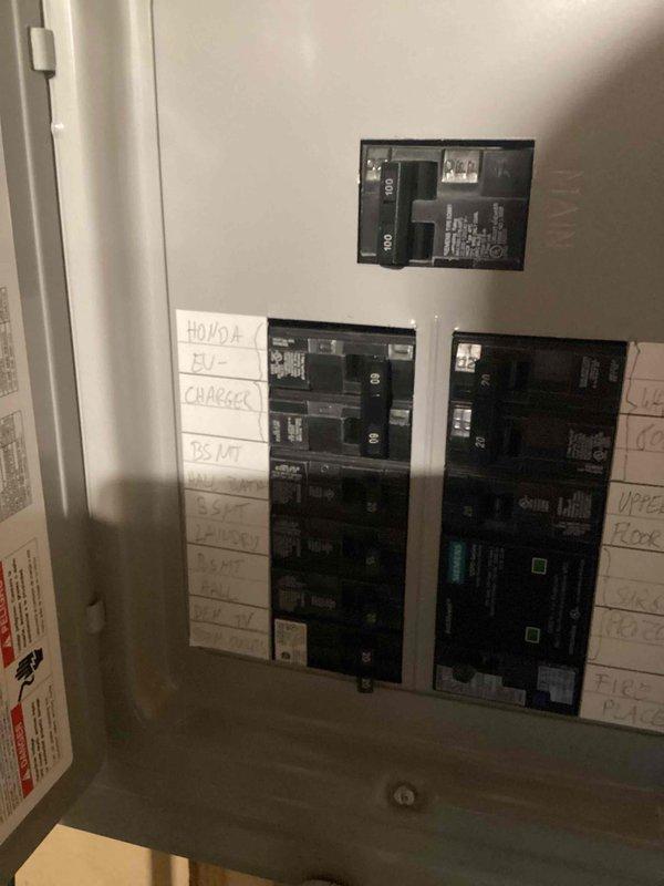 Successfully replaced an Enel X Juicebox EV charger with an Electrum-supplied Emporia EV charger, routing surface-mounted conduit from the existing junction box to the new charging station. Documented installation with photos of the electrical panel showing proper breaker installation and the installed EV charger including serial number verification as required.