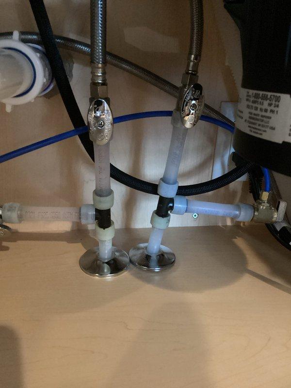 Performed warranty service on kitchen faucet that presented with multiple issues: dripping, sprayer hose hanging up, loose sprayer hose, and loose cold side handle. Replaced cartridges, repositioned sprayer hose behind supply lines to prevent hanging, and tightened both the sprayer hose and cold side mounting bracket under sink to restore proper functionality.