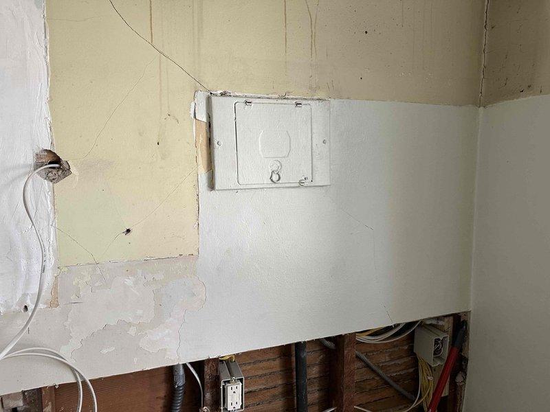 Completed electrical installation work for kitchen remodel including the relocation of refrigerator outlet, installation of new 220V outlet for dryer and 120V outlet for washer in stacked configuration. Installed six code-compliant GFI-protected countertop outlets on existing arc-faulted circuits, relocated gas range outlet, and wired new range hood. Toe kick heater installation pending arrival of unit.