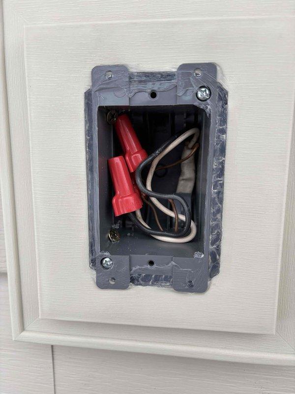 Completed rough-in electrical installation for one exterior light fixture on the right elevation of Woodbury Siding. Installation included mounting junction box, completing necessary wiring connections, and securing the light fixture to specifications.