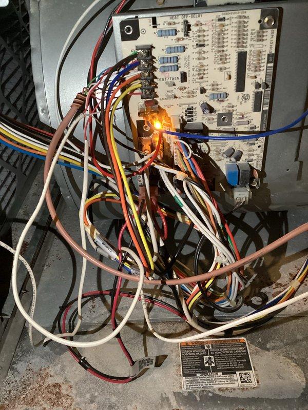 Responded to after-hours call for heating system malfunction where AC was activating during heat calls. Diagnosed faulty thermostat as primary issue with possible circuit board failure as secondary concern. Replaced thermostat to restore proper system operation; circuit board showing illuminated status LED was left for monitoring to determine if replacement will be necessary during follow-up.