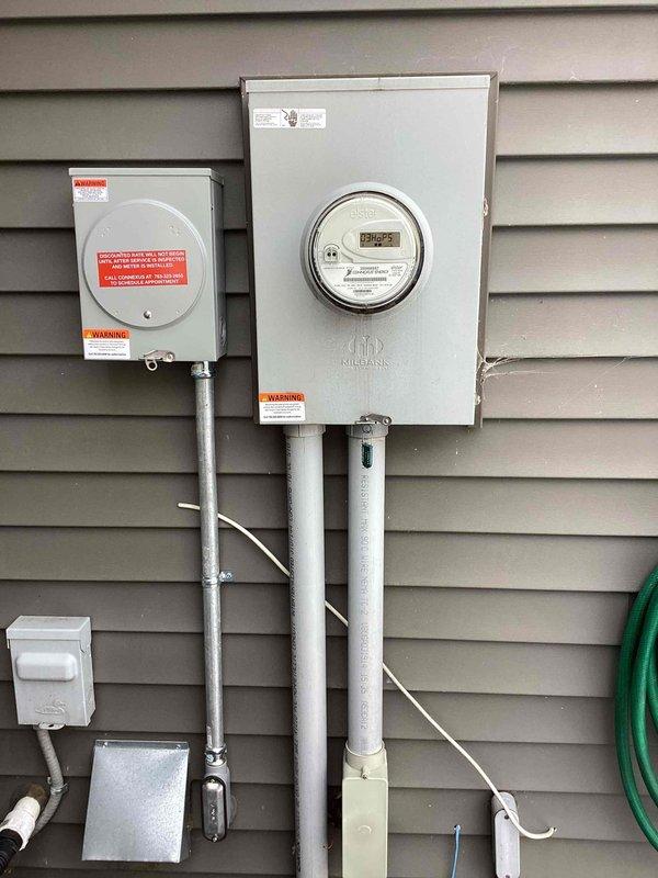 Successfully installed a Connexus Time-of-Day sub-meter on the building exterior adjacent to the main electrical meter socket, establishing the infrastructure for electric vehicle charging. Completed the EV circuit installation from the 200amp Eaton BR panel through the sub-meter, running surface-mounted conduit through the basement and into the garage where the customer-supplied Tesla charger was mounted on the left wall near the overhead door. All work was completed according to code specifications and is ready for final inspection by Connexus Energy for meter activation.
