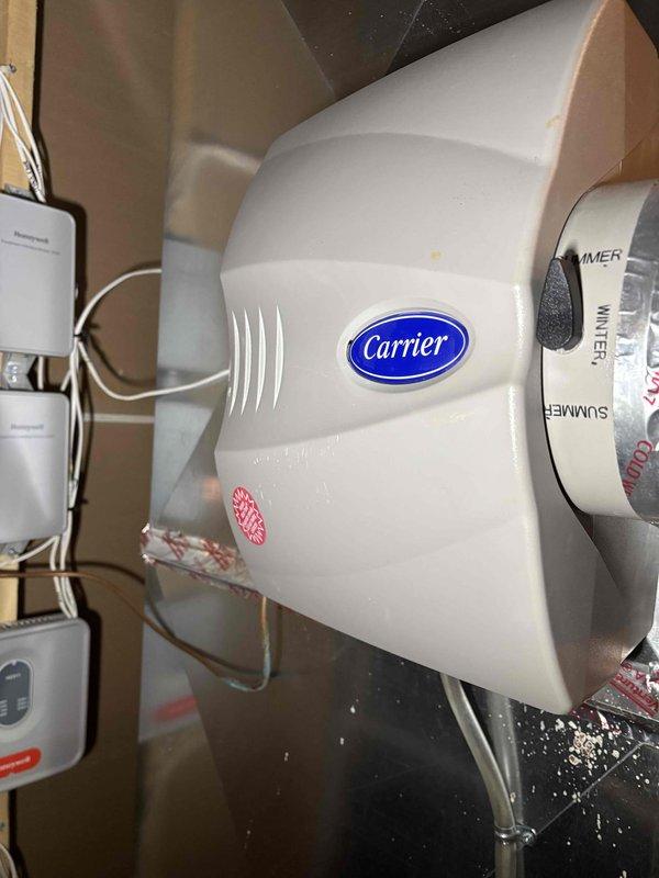 Performed scheduled prepaid maintenance service on heating system including inspection of Carrier furnace, gas fireplace, and humidifier. Examined humidifier components and damper control settings. Inspected air filtration system and noted moderate particulate accumulation on filter media, though still functional. All systems operating within normal parameters.