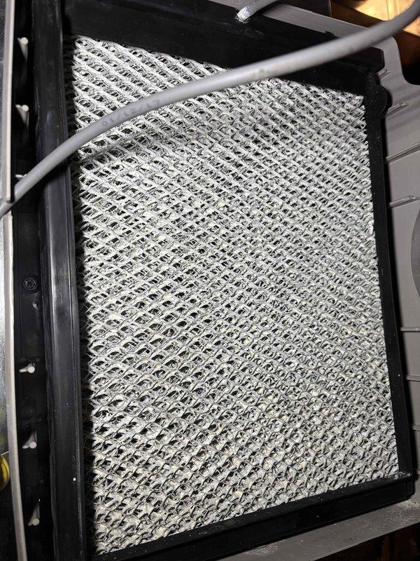 Performed scheduled prepaid maintenance service on heating system including inspection of Carrier furnace, gas fireplace, and humidifier. Examined humidifier components and damper control settings. Inspected air filtration system and noted moderate particulate accumulation on filter media, though still functional. All systems operating within normal parameters.