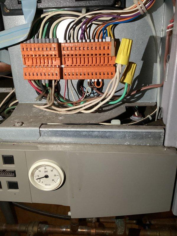 Diagnosed in-floor heating system failure traced to a non-functioning circulation pump. Verified pump was receiving power but not operating. Removed failed pump and installed replacement unit, ensuring proper electrical connections and system operation. System now functioning correctly with normal pressure readings.