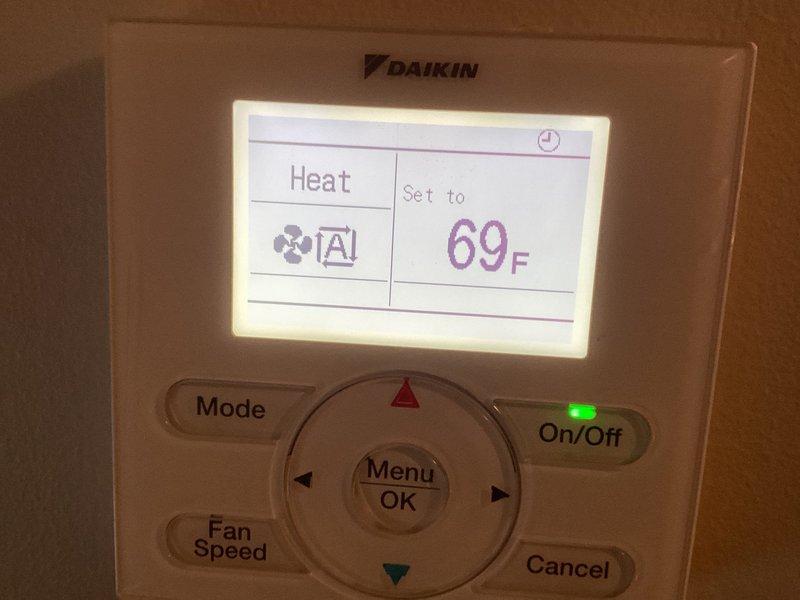 Responded to after-hours service call for mini split system showing error code and no heat upstairs - an ongoing issue previously serviced in July and October. Conducted diagnostic testing using handheld measurement device at ceiling registers and verified Daikin thermostat settings (set to heat mode at 69°F). Due to darkness and potential issues with air, moisture, or refrigerant levels, service was suspended and rescheduled for comprehensive troubleshooting.