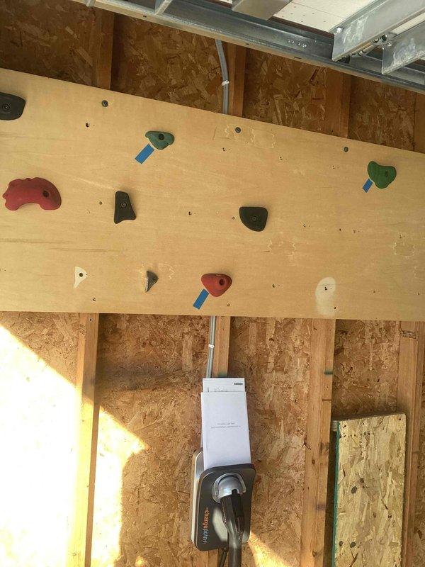 Successfully installed a 40-amp, 240V EV charging circuit from the main 100-amp Square D HOM electrical panel. Circuit was routed through ceiling soffit, crawlspace and garage wall, terminating at a junction box near the garage door. Installation included surface-mounted conduit and 60-amp rated wiring to allow for future expansion capacity, with a tandem breaker installed to accommodate the new 240V circuit.