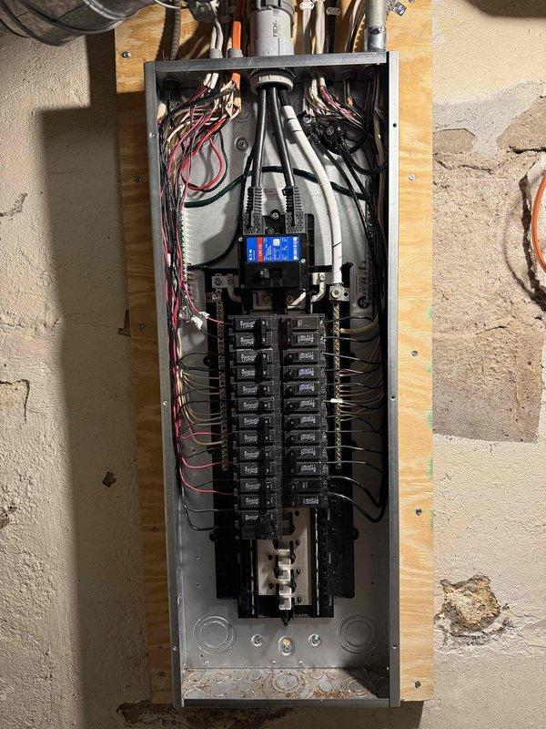 Successfully completed a 200 amp electrical service upgrade, installing a new outdoor meter enclosure with extended service mast to meet NEC clearance requirements. Replaced the existing panel with a new 200 amp 40-space main electrical panel in the unfinished basement, reconnecting all circuits with new breakers, and installed a whole home surge protective device along with proper grounding using two 8' ground rods and bonding to the water meter.