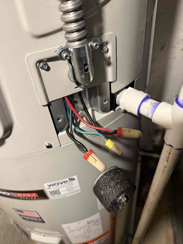 Replaced existing power vent water heater with new Bradford White G2 50-Gallon Electric Hybrid Heat Pump Water Heater (M# RE2HP5010-1NCTT). Relocated unit for improved accessibility near exterior wall and electrical panel, disconnected gas line and capped, installed new water isolation shut-off valves to code, and connected condensate line to floor drain in laundry room. System tested with no leaks detected.