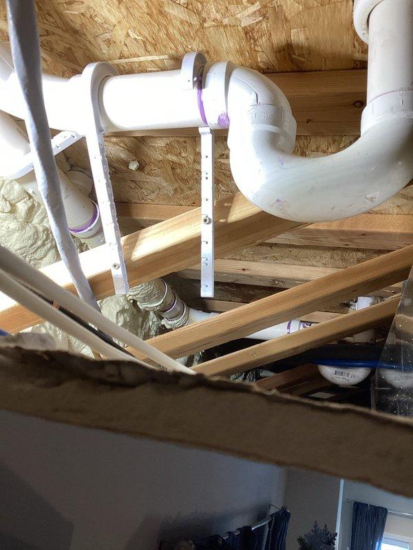 Located and addressed a bathtub drain leak by cutting an access point through the ceiling. Identified the issue as an incorrect rubber gasket and ordered the proper replacement. Installed additional strapping to secure the drain assembly and prevent future disconnection, completing installation of rough-in plate through shower access with 1-year workmanship warranty.