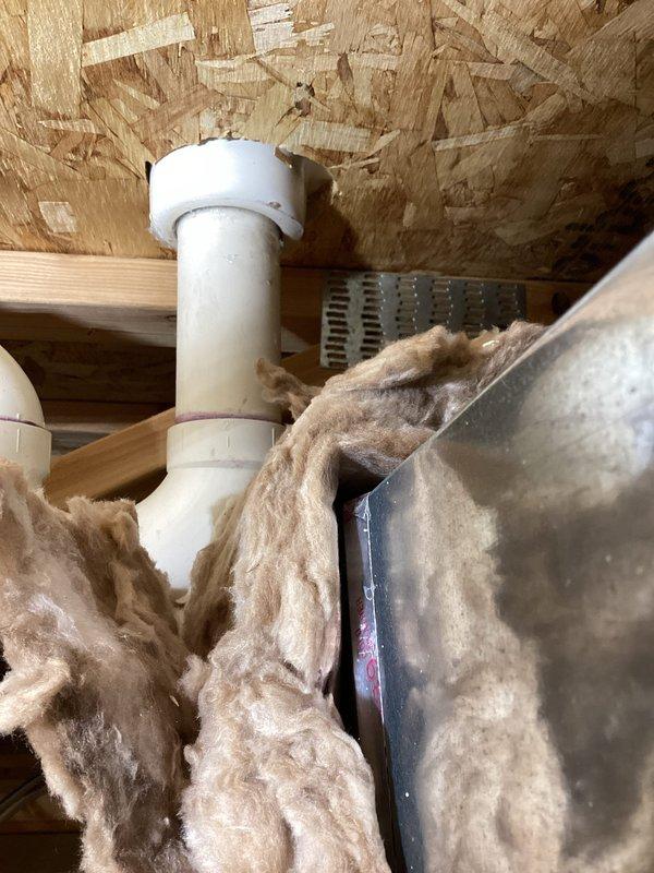 Located and addressed a bathtub drain leak by cutting an access point through the ceiling. Identified the issue as an incorrect rubber gasket and ordered the proper replacement. Installed additional strapping to secure the drain assembly and prevent future disconnection, completing installation of rough-in plate through shower access with 1-year workmanship warranty.