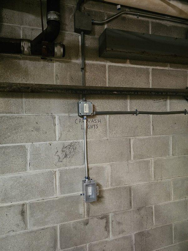 Installed new electrical outlet near car wash in parking garage as requested by client. Mounted junction box on concrete block wall, ran conduit from existing supply to new outlet location, and connected to power source. Verified proper functionality of outlet upon completion.