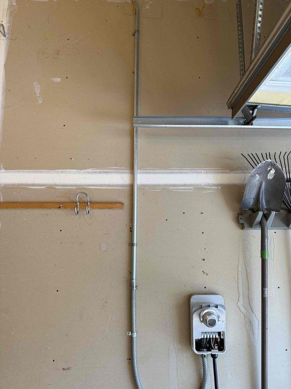 Successfully installed and hardwired a 60-amp EV charging station on the garage wall with surface-mounted conduit for protection, allowing for 48-amp output capability. Completed programming and setup of the charging unit, and installed a dedicated 120V 20-amp tamper-resistant GFCI outlet as specified in the project scope. All work was completed according to specifications and photo documentation was taken of the installation.