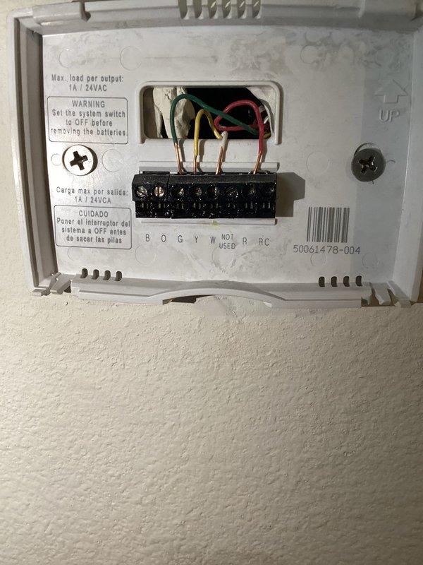 Responded to service call at Just Off Main property (tenant residence). Removed outdated thermostat and installed new Honeywell T6 programmable model. Confirmed proper wiring connections (B, O, G, Y, W, R, RC terminals) and verified system operation with temperature display showing 60 degrees.
