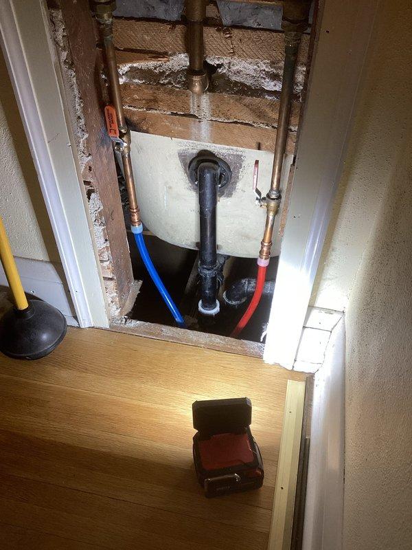 Responded to first floor bathroom toilet leak that was causing water damage to kitchen ceiling below. Diagnostic assessment revealed damaged wax ring at toilet base and broken one-piece tubular drain nut on tub. Completed toilet pull and reset with new wax ring installation and replaced damaged tubular nut on tub drain assembly to resolve both leak sources.