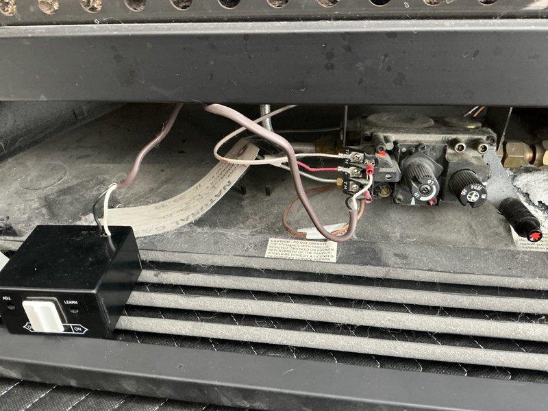 Responded to service call for gas fireplace not producing flame despite pilot light being on. Diagnosed loose wiring connections in receiver box requiring replacement. Performed routine tune-up on the unit and verified proper operation of Skytech remote control system. Fireplace now functioning correctly as supplemental heat source for office.